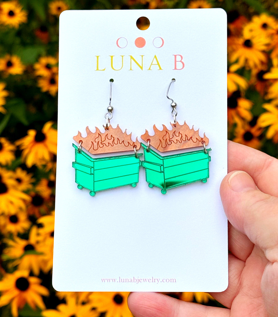 Dumpster fire-shaped acrylic earrings with bright flame details, laser-cut and handmade with stainless steel ear wires.