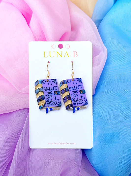 Smut book-shaped acrylic earrings with gold-plated, nickel-free stainless steel hooks, handmade for romance and fantasy readers.