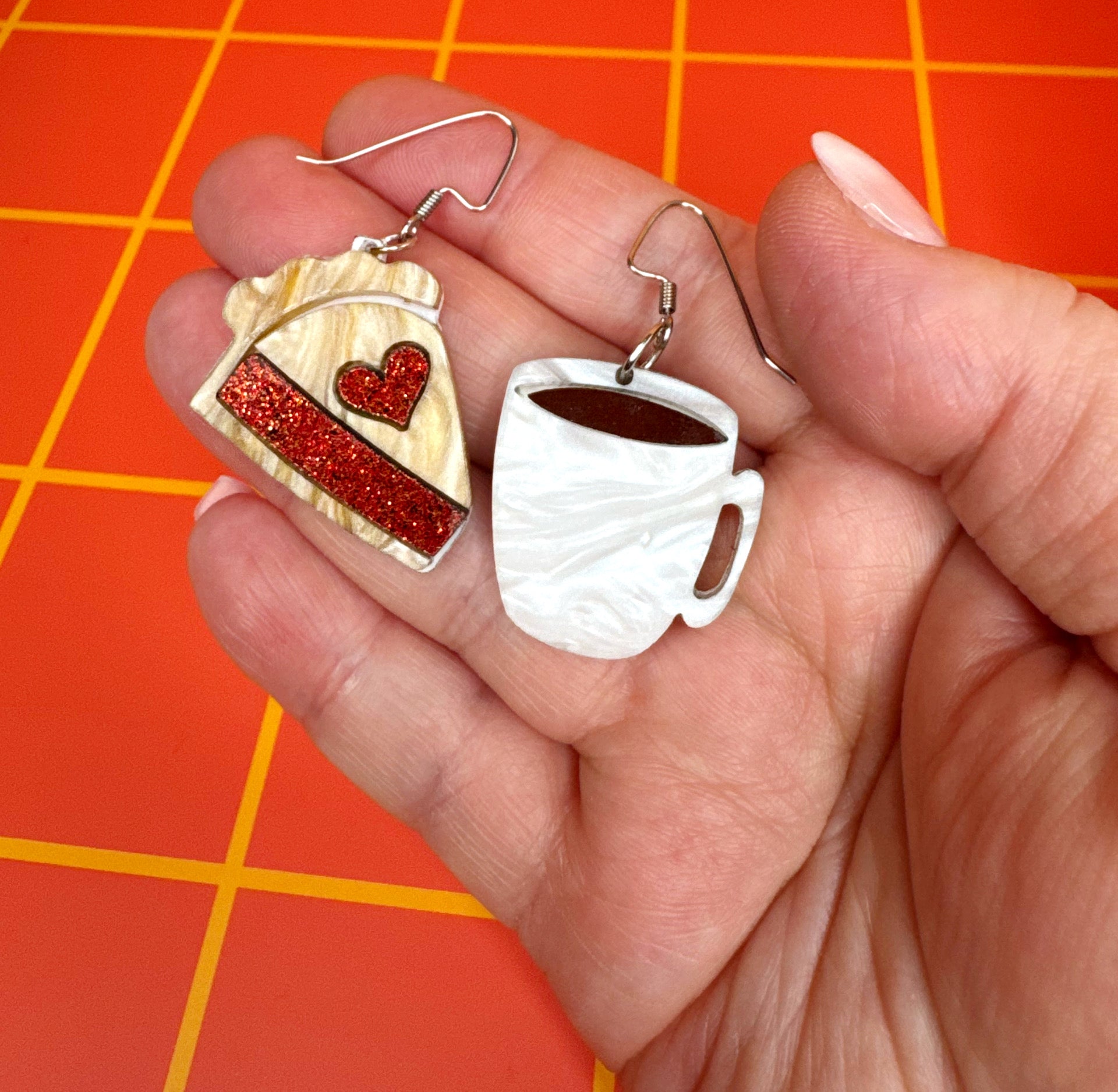 Mismatched Twin Peaks earrings featuring cherry pie and coffee cup designs, laser-cut acrylic with stainless steel ear wires.