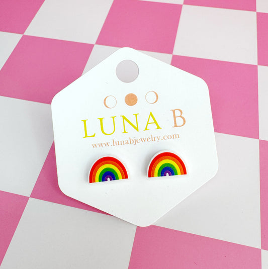 Small handmade rainbow stud earrings with bright rainbow stripes, set on hypoallergenic stainless steel posts, displayed on Luna B backing card.