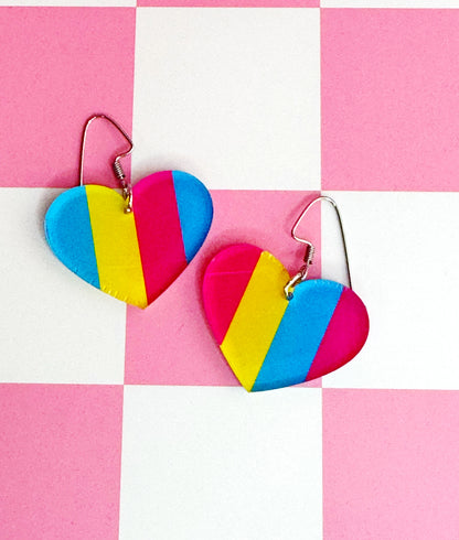 Handmade laser-cut acrylic earrings in pansexual Pride colors—pink, yellow, and blue—set on hypoallergenic stainless steel ear wires.